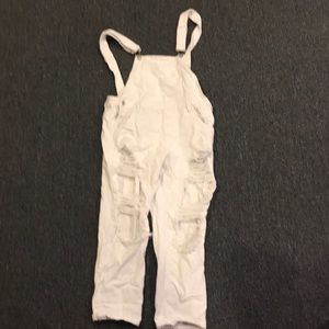 White ripped jean overalls